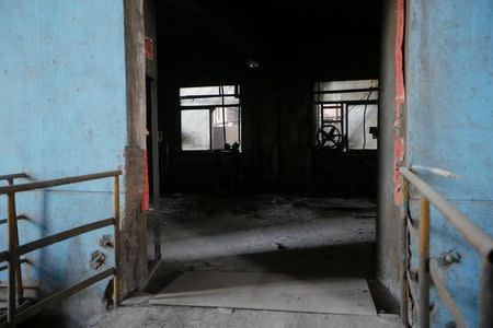 The view through a doorway of a closed steel mill in Wenshui county, Shanxi Province, China, April 29, 2016. REUTERS/John Ruwitch