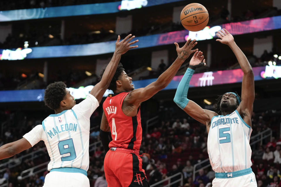 Houston Rockets guard Jalen Green (4) shoots as Charlotte Hornets center Mark Williams (5) and guard Theo Maledon (9) defend during the first half of an NBA basketball game Wednesday, Nov. 1, 2023, in Houston. (AP Photo/Eric Christian Smith)