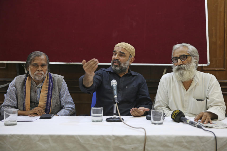 Social activist Faisal Khan of Khudai Khidmatgar, an organization founded by freedom fighter Khan Abdul Gaffar Khan, addresses a press conference seated with activist and education reformer Sandeep Pandey, right, and Prafulla Samantara in New Delhi, India, Saturday, Oct. 5, 2019. Pandey and a U.S. senator were barred from visiting Indian-administered Kashmir, the disputed Himalayan territory where at least 10 people were injured Saturday in a grenade blast as a government security and communications lockdown entered a third month. (AP Photo/Altaf Qadri)