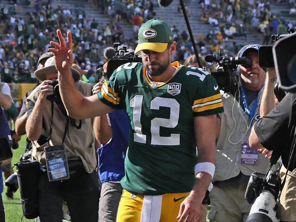 Aaron Rodgers waves to fans after a game.