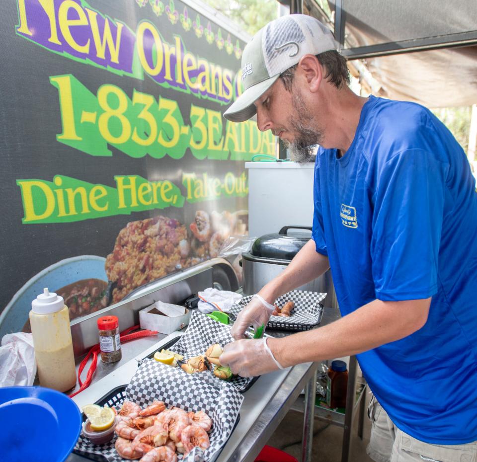 Co-owner Will Lumpkin plates some orders at Where Y'at Seafood Market & Restaurant at 4233 Highway 87 in Navarre on March 31, 2021.