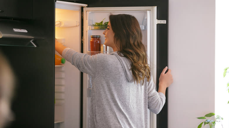 A woman opening the fridge
