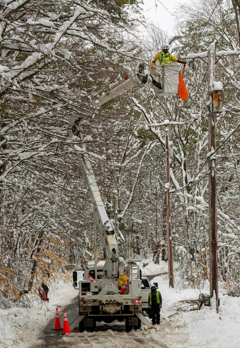 A lineman works on power lines on Mill Glen Road in Winchendon near the Gardner town line Wednesday.