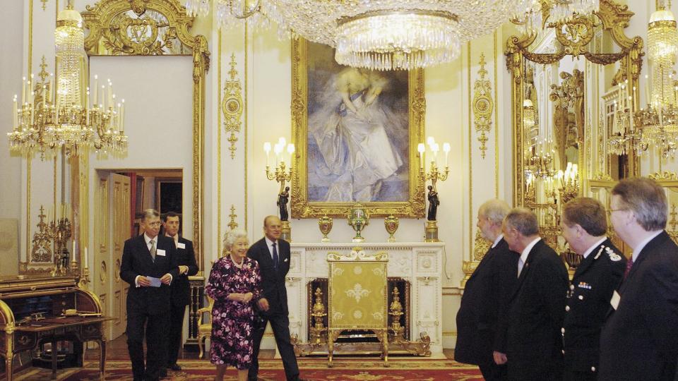 The Queen and Prince Philip with staff inside Buckingham Palace