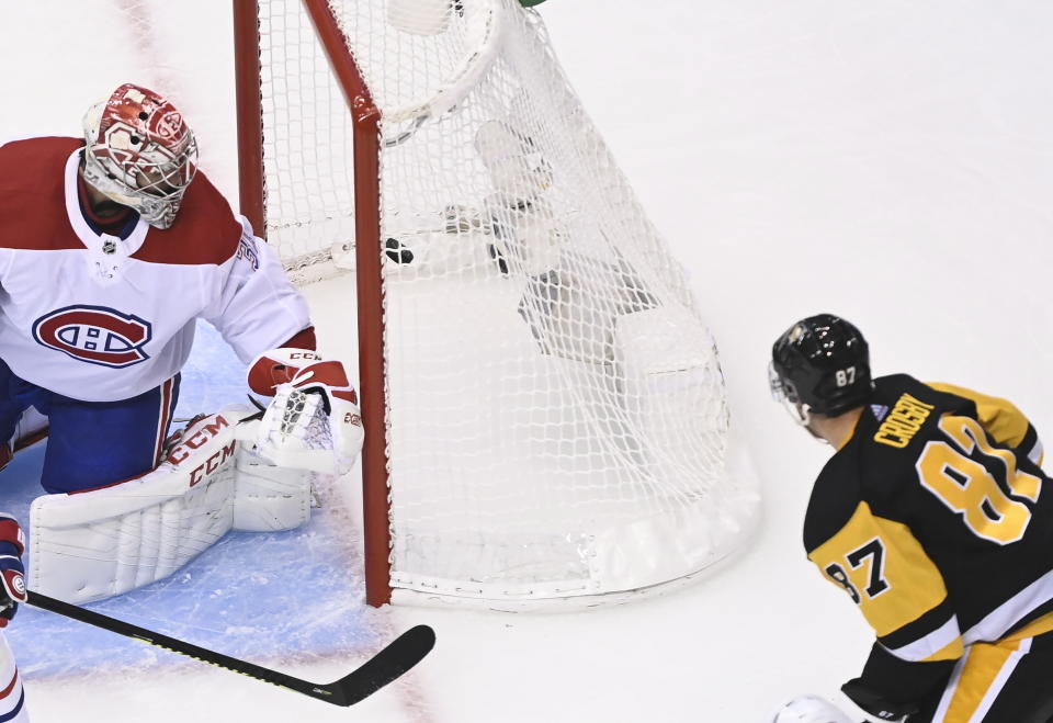 Pittsburgh Penguins center Sidney Crosby (87) scores on Montreal Canadiens goaltender Carey Price (31) during the second period of an NHL hockey playoff game in Toronto, Saturday, Aug. 1, 2020. (Nathan Denette/The Canadian Press via AP)