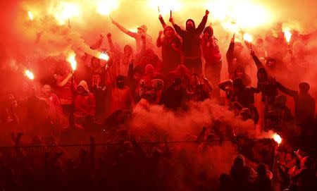 Galatasaray fans light flares to celebrate their goal against Fenerbahce during the Turkish Super League derby soccer match between Galatasaray and Fenerbahce in Istanbul, Turkey in this April 6, 2014 file photo. REUTERS/Murad Sezer/Files