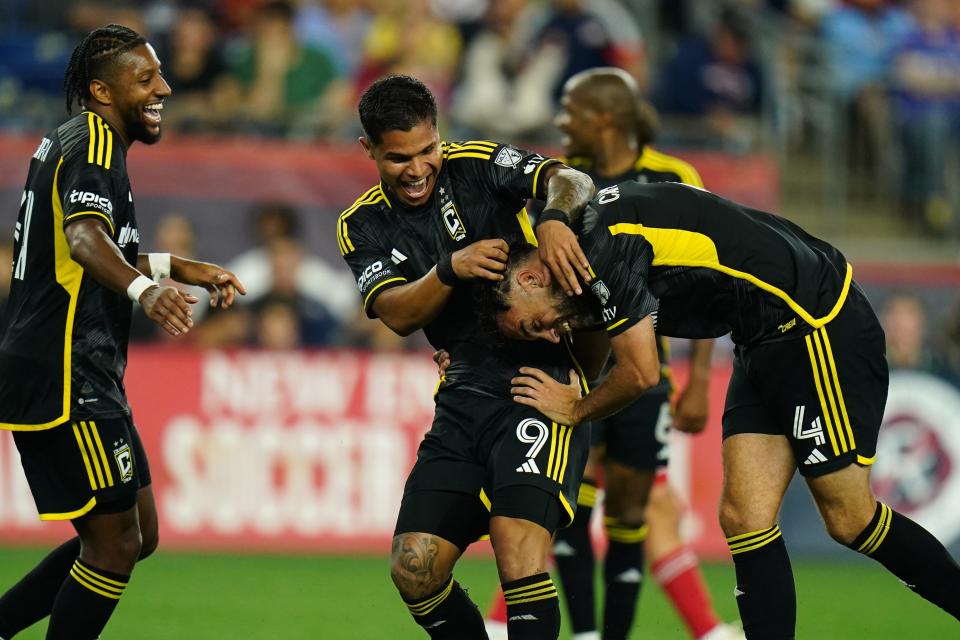 Crew defender Rudy Camacho (4) celebrates with forward Cucho Hernandez (9) and teammates after scoring a goal in a 5-1 win against New England.