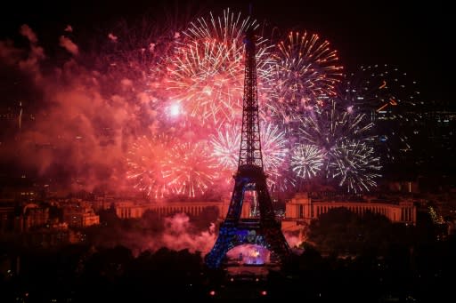 Fireworks surround the Eiffel Tower for Bastille Day celebrations on Sunday, the day before France plays in the World Cup final