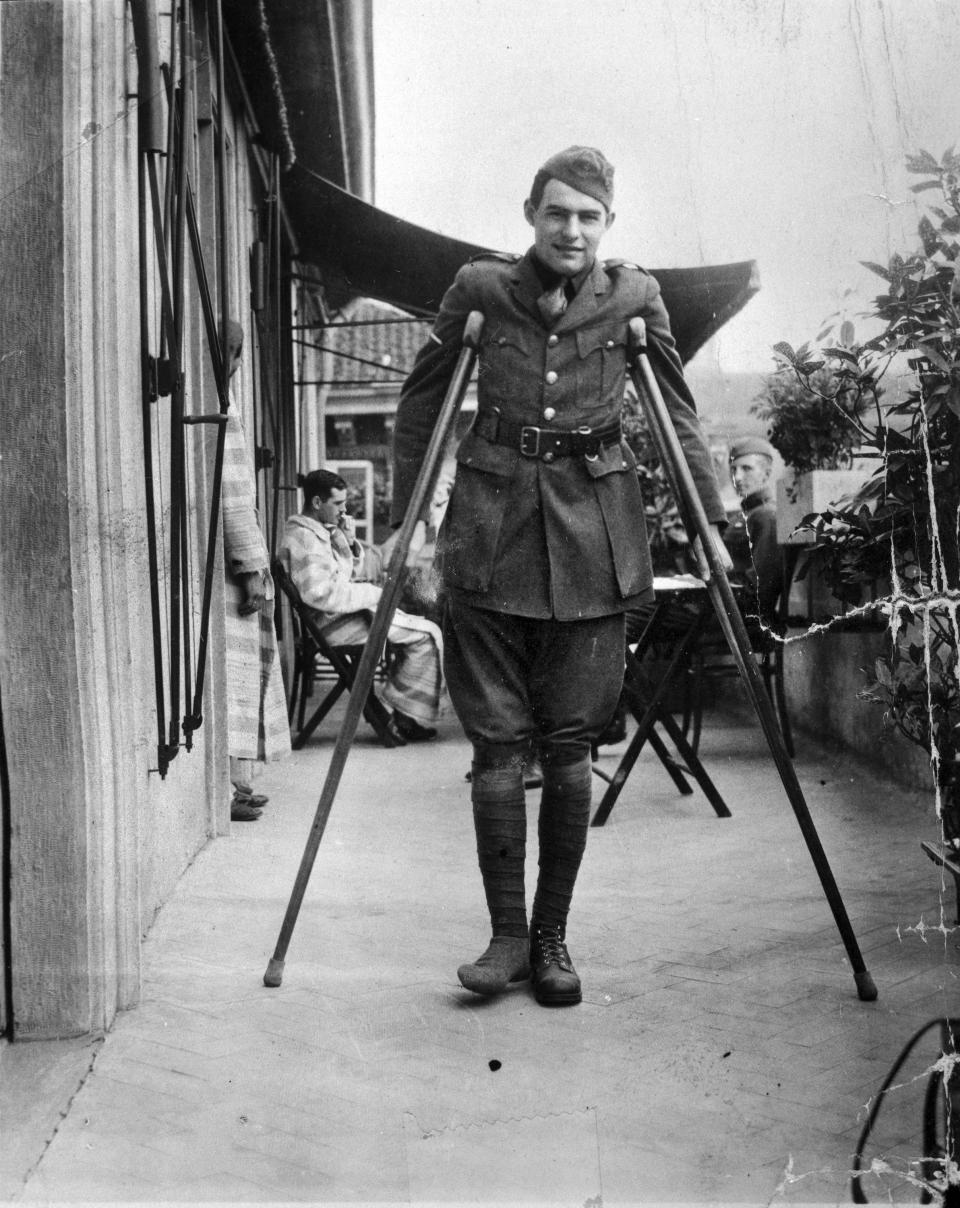 This 1918 photo provided by the John F. Kennedy Library Foundation from the Ernest Hemingway Collection shows Ernest Hemingway on crutches in Milan, Italy, where he was convalescing after being wounded while serving as an ambulance driver during World War I. A new three-part documentary about Hemingway, which relied heavily on the archives at the John F. Kennedy Presidential Library and Museum in Boston, debuts April 5, 2021, on PBS. (John F. Kennedy Presidential Library and Museum, Boston via AP)