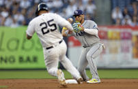 Tampa Bay Rays second baseman Isaac Paredes turns a double play on New York Yankees' Aaron Judge after forcing out Gleyber Torres (25) during the first inning of a baseball game Monday, Aug. 15, 2022, in New York. (AP Photo/Adam Hunger)