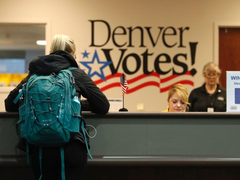 A voter fills out her ballot in Denver, Colorado.