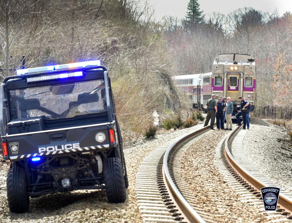 A commuter rail train going through Cohasset on Tuesday morning was forced to stop to avoid hitting a woman on the tracks.