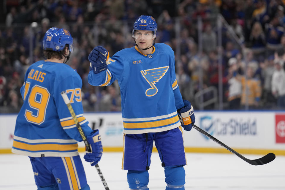 St. Louis Blues' Colton Parayko, right, is congratulated by Sammy Blais (79) after scoring during the second period of an NHL hockey game against the Chicago Blackhawks Saturday, Dec. 23, 2023, in St. Louis. (AP Photo/Jeff Roberson)