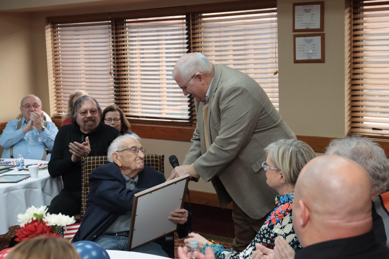 State Rep. Dale Zorn, R-Onsted, presents Ted Dusseau, seated, with a state tribute for his three decades as the Lenawee County Republican Party chairman during Ted Dusseau Day Saturday, Feb. 25, 2023, at the Carlton Lodge in Adrian.