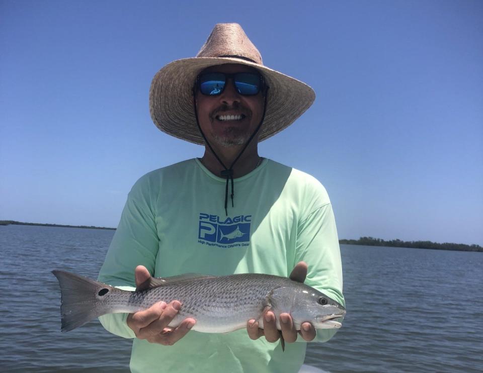 Don Bolden with a catch-and-release redfish, aboard Art Mowery's boat in the Oak Hill/Tiger Shoal area.