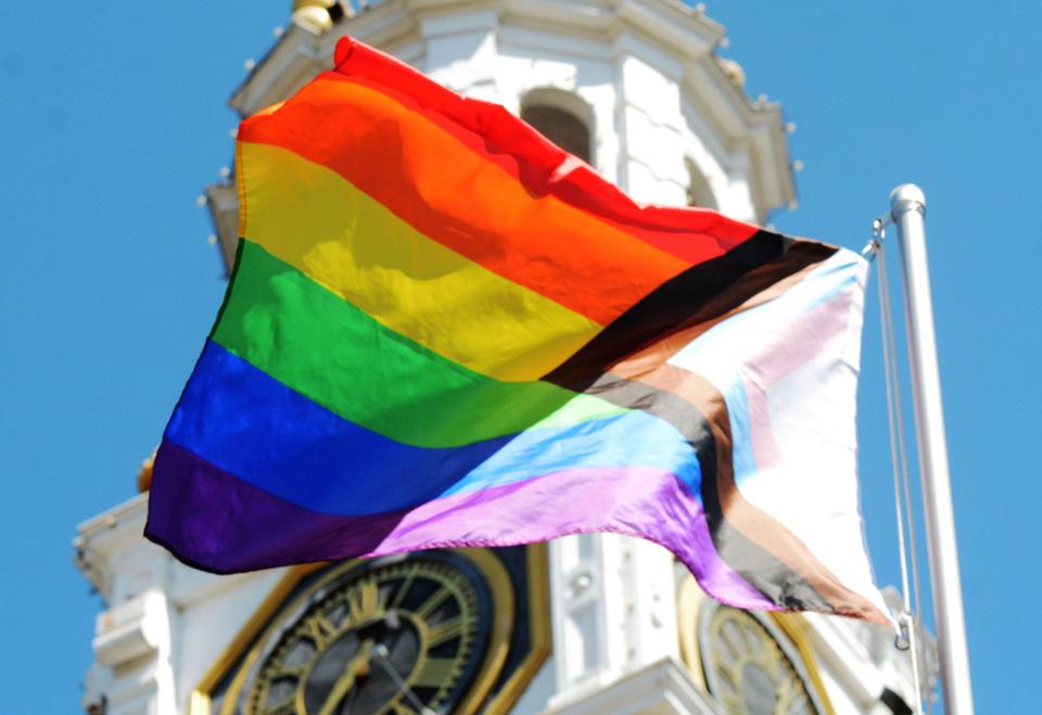 The Pride Flag is raised during a ceremony Tuesday at Norwich City Hall.