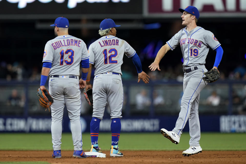 New York Mets' Luis Guillorme (13), Francisco Lindor (12) and Mark Canha (19) celebrate after the team's baseball game against the Miami Marlins, Friday, June 24, 2022, in Miami. The Mets won 5-3. (AP Photo/Lynne Sladky)