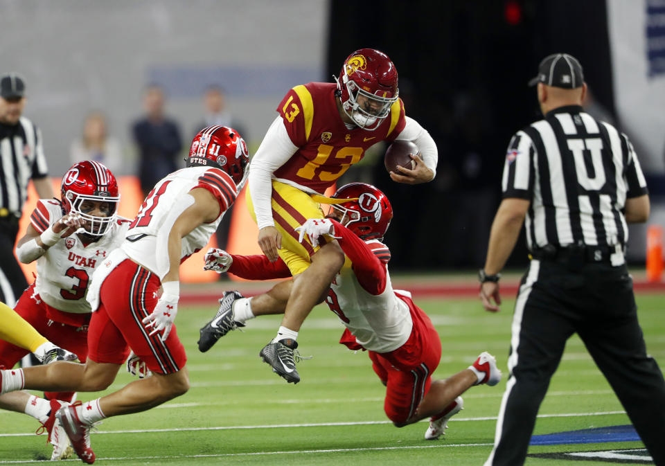 USC quarterback Caleb Williams (13) is tackled by Utah safeties RJ Hubert (11) and Cole Bishop (8) during the Pac-12 championship game on Friday, Dec.  2, 2022, in Las Vegas.  (AP Photo/Steve Marcus)