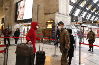 Police officers and soldiers check passengers leaving from Milan main train station, Italy, Monday, March 9, 2020. Italy took a page from China's playbook Sunday, attempting to lock down 16 million people — more than a quarter of its population — for nearly a month to halt the relentless march of the new coronavirus across Europe. Italian Premier Giuseppe Conte signed a quarantine decree early Sunday for the country's prosperous north. Areas under lockdown include Milan, Italy's financial hub and the main city in Lombardy, and Venice, the main city in the neighboring Veneto region. (AP Photo/Antonio Calanni)