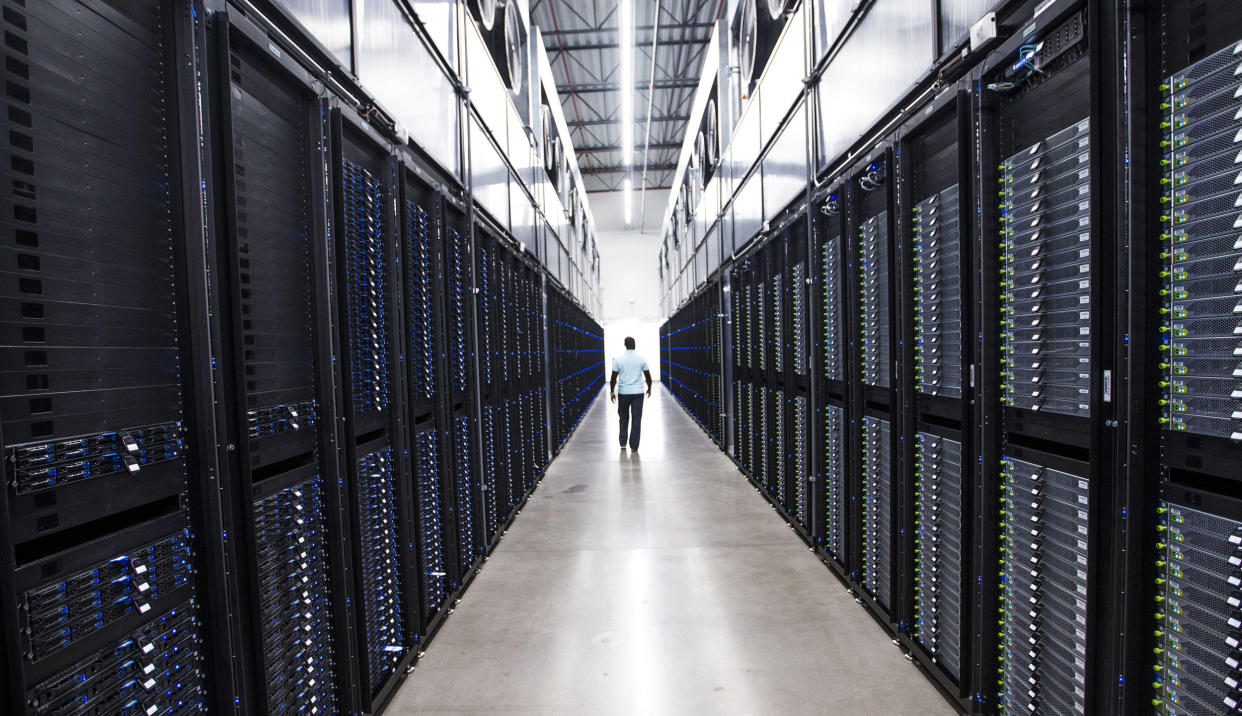 The senior site operations manager at the Apple Data Center in Mesa makes his way past dozens of servers on Aug. 14, 2018. (Tom Tingle / The Republic / USA Today Network)
