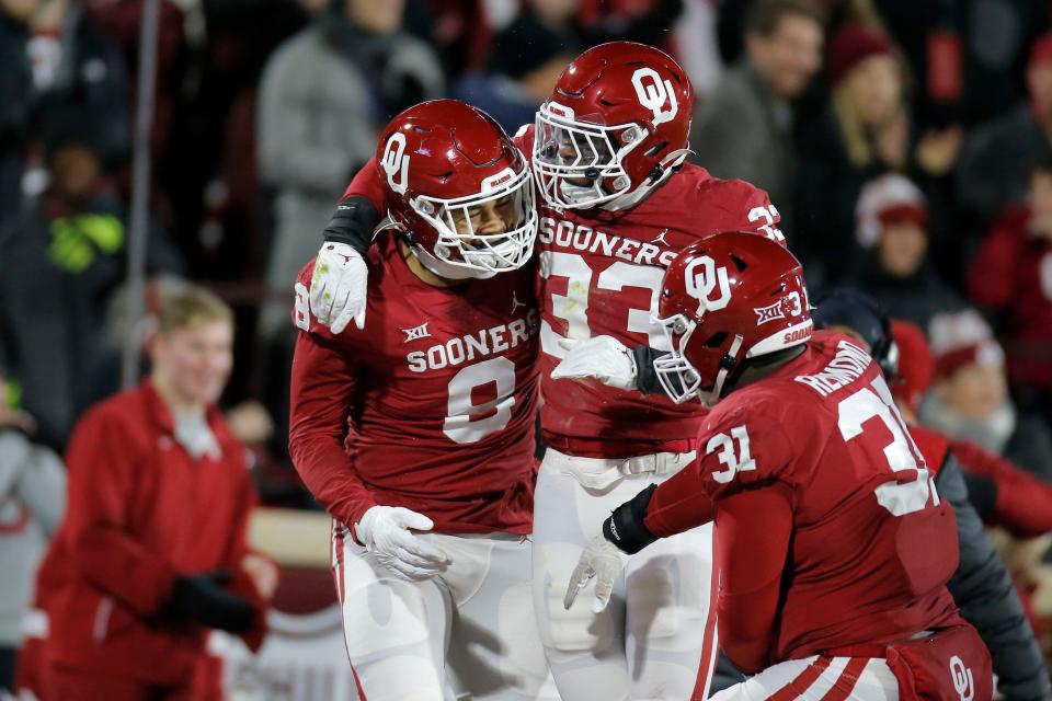 Oklahoma's Jonah Laulu (8), Marcus Stripling (33) and Jalen Redmond (31) celebrate after Laulu intercepted a pass during a Bedlam college football game between  the University of Oklahoma Sooners (OU) and the Oklahoma State University Cowboys (OSU) at Gaylord Family-Oklahoma Memorial Stadium in Norman, Okla., Saturday, Nov. 19, 2022. 