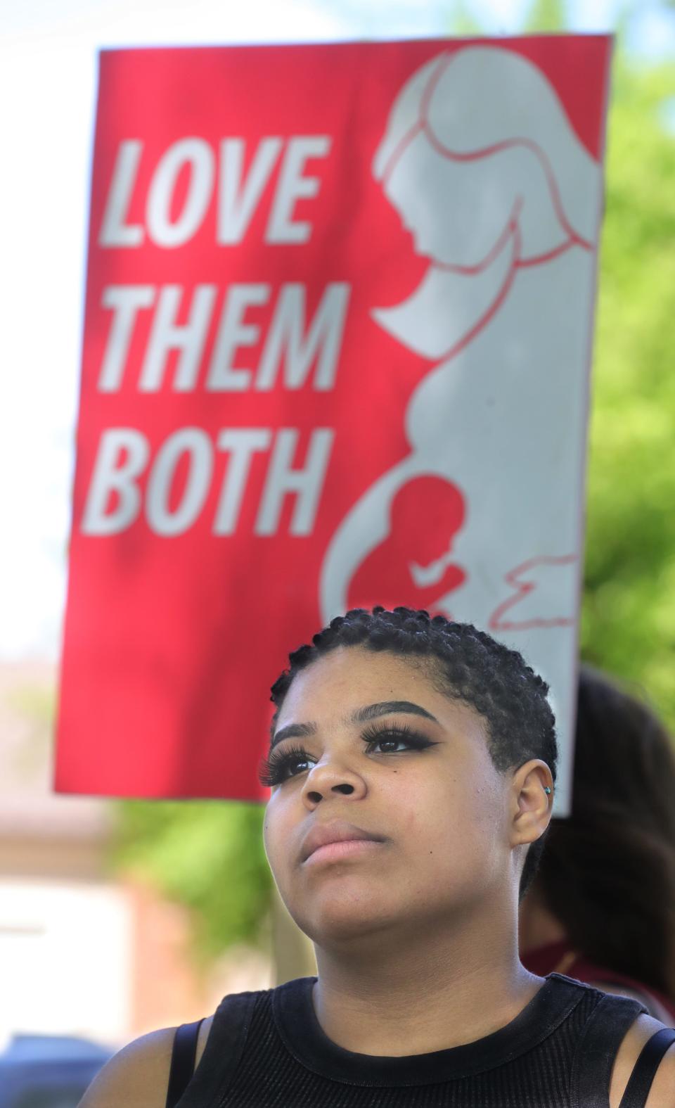 Anti-abortion rally organizer Constance Hairston listens to Right to Life of Northeast Ohio Executive Director Allie Frazier speak Sunday at Croghan Park in Fairlawn.