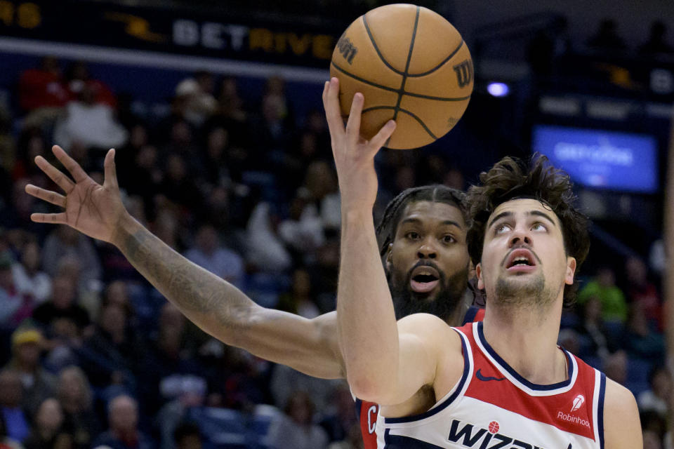 Washington Wizards forward Deni Avdija (8) shoots against New Orleans Pelicans forward Naji Marshall (8) during the second half of an NBA basketball game in New Orleans, Wednesday, Feb. 14, 2024. (AP Photo/Matthew Hinton)