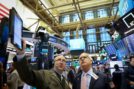 FILE PHOTO: Traders work on the floor of the New York Stock Exchange (NYSE) in New York, U.S., February 13, 2019. REUTERS/Brendan McDermid