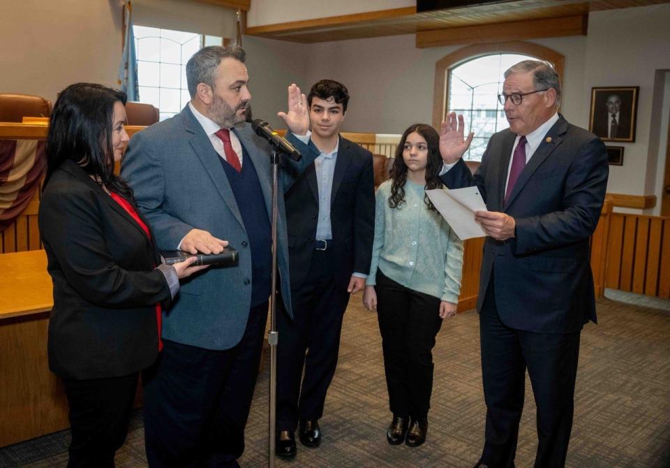 Daniel Rodrick takes the oath of office as Toms River Mayor from state Sen. Jon Bramnick, R-N.J., while his wife, Diana, holds the Bible and his children, Daniel and Samantha, look on.