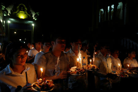 People hold offerings while praying for loved ones who have passed away during the first day of Pchum Ben festival, or the festival of the dead in Phnom Penh, Cambodia, September 25, 2018. REUTERS/Samrang Pring