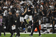 Las Vegas Raiders cornerback Casey Hayward (29) and quarterback Derek Carr (4) celebrate after defeating the Baltimore Ravens during overtime in an NFL football game, Monday, Sept. 13, 2021, in Las Vegas. (AP Photo/David Becker)