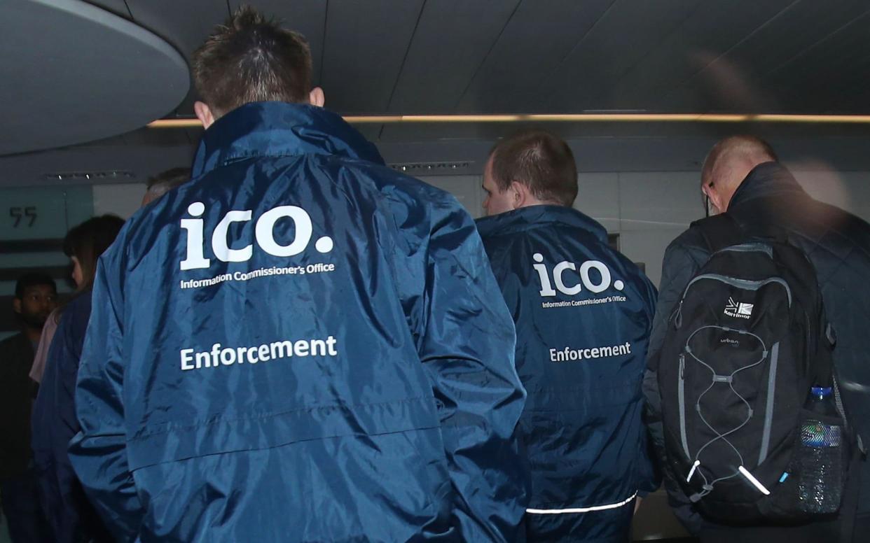 Enforcement officers working for the Information Commissioner's Office enter the offices of Cambridge Analytica in central London - PA