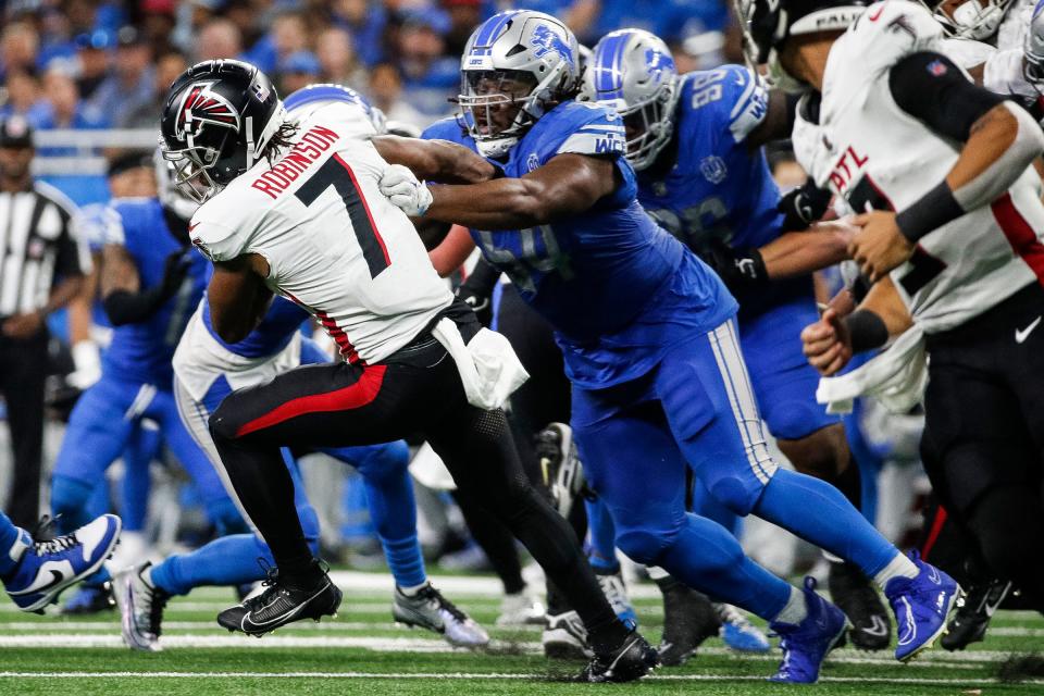 Detroit Lions defensive tackle Alim McNeill (54) tackles Atlanta Falcons running back Bijan Robinson (7) during the second half at Ford Field in Detroit on Sunday, Sept. 24, 2023.