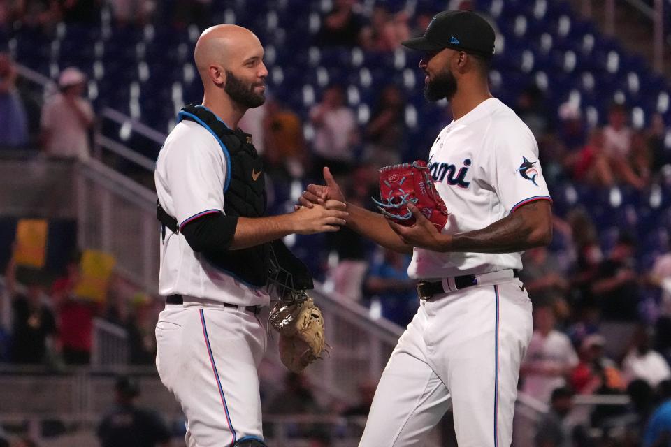 Marlins catcher Jacob Stallings celebrates with pitcher Sandy Alcantara after his complete-game shutout of the Cincinnati Reds in Miami on Wednesday night.