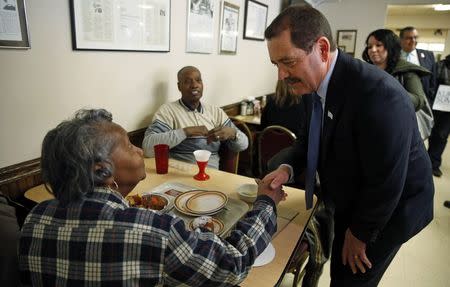 Chicago Mayoral candidate Jesus "Chuy" Garcia (R) greets restaurant patrons, during a campaign stop on election day in Chicago, Illinois, in this file photo taken February 24, 2015. REUTERS/Jim Young/Files