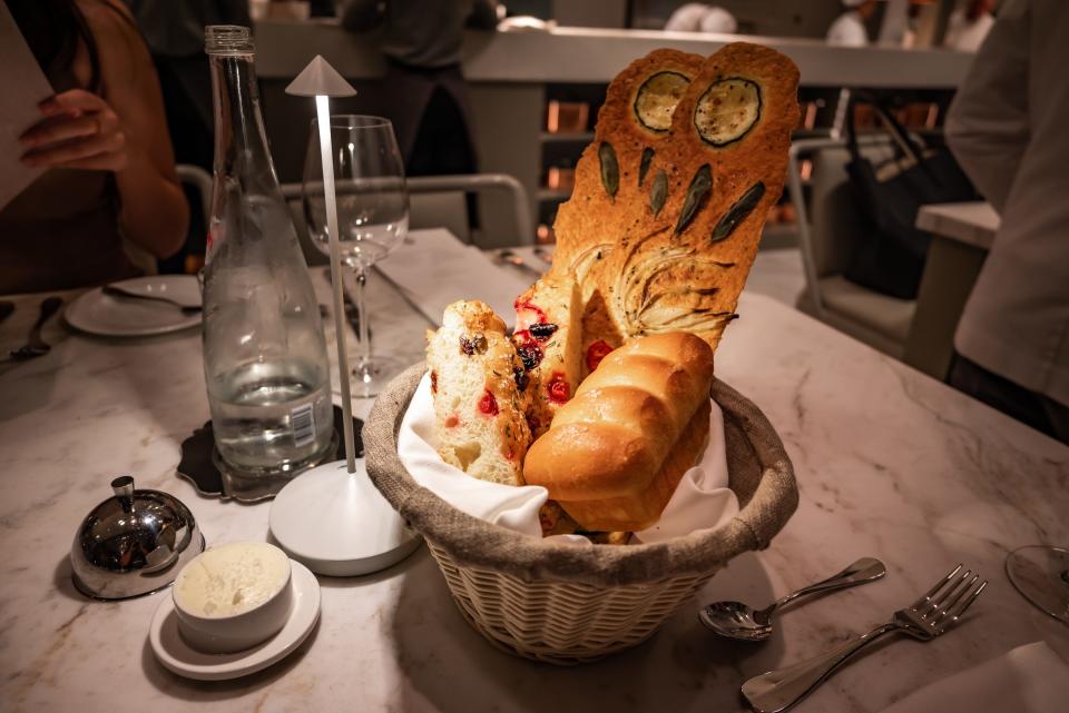 basket stuffed with various breads