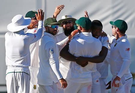 Cricket - Australia v South Africa - First Test cricket match - WACA Ground, Perth, Australia - 6/11/16 South Africa's wicketkeeper Kagiso Rabada celebrates with team mates after dismissing Australia's captain Steve Smith at the WACA Ground in Perth. REUTERS/David Gray