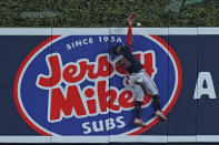 Atlanta Braves center fielder Michael Harris II is unable to catch a ball hit by Miami Marlins' Bryan De La Cruz for a home run scoring Joey Wendle, during the third inning of a baseball game, Monday, Oct. 3, 2022, in Miami. (AP Photo/Wilfredo Lee)