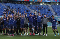 Slovakian players celebrate at the end of the Euro 2020 soccer championship group E match between Poland v Slovakia at the Saint Petersburg stadium in St. Petersburg, Russia, Monday, June 14, 2021. (Evgenya Novozhenina/Pool via AP)