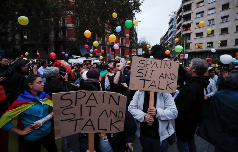 Pro-independence activists gather with balloons during a protest outside the Spanish government delegation offices in Barcelona