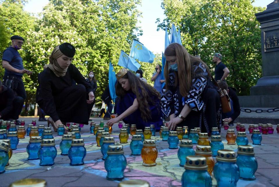 People arrange vigil lanterns in memory of the victims of the 1944 deportation of Crimean Tatars on May 18 in Odesa, Ukraine. (Yulii Zozulia/ Ukrinform/Future Publishing via Getty Images)