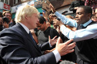 Mayor Boris Johnson attempts to calm residents in Lewisham, London on Tuesday as he returned from holiday to help coordinate clean-up efforts.