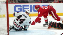 Detroit Red Wings center Robby Fabbri (14) scores pas Chicago Blackhawks defenseman Calvin de Haan (44) in the second period of an NHL hockey game Wednesday, Jan. 26, 2022, in Detroit. (AP Photo/Paul Sancya)
