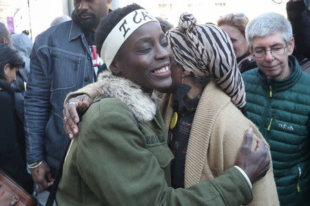 Therese Patricia Okoumou is embraced after her sentencing for conviction on attempted scaling of the Statue of Liberty to protest the U.S. immigration policy, outside a federal court in New York, U.S., March 19, 2019. REUTERS/Shannon Stapleton