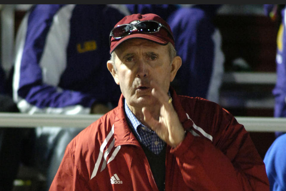 FILE - In this May 14, 2006, file photo, John McDonnell, coach of the Arkansas men's track team, shouts to team members during the 5,000 meter run at the Southeastern Conference Outdoor Track and Field Championships in Fayetteville, Ark. John McDonnell, the track and field coach who set a gold standard for excellence at Arkansas during his 36 years at the school, has died. He was 82. He died Monday night, June 7, 2021, according to a family statement released by the university. (AP Photo/April L. Brown, File)