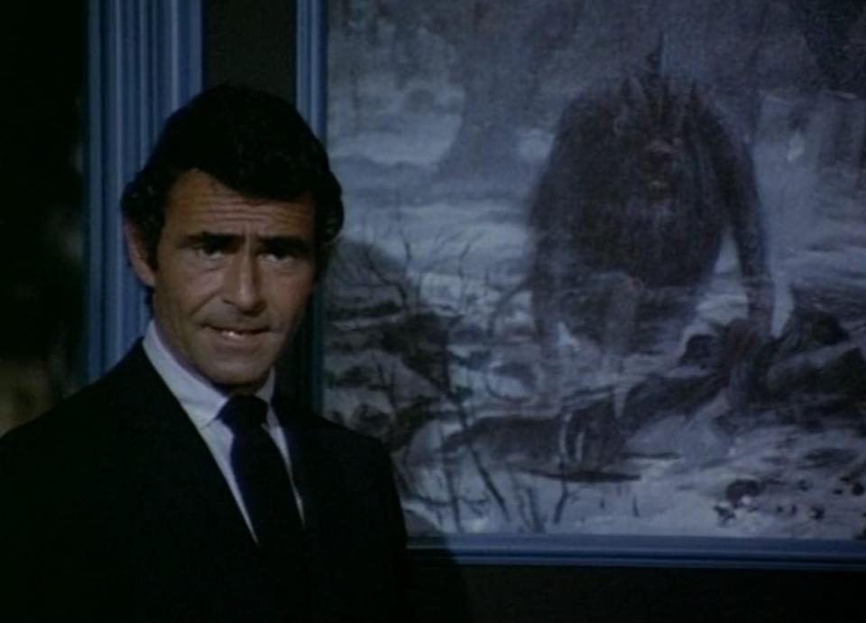 Rod Serling stands in front of a painting of a hideous creature in the Night Gallery episode "Pickman's Model"