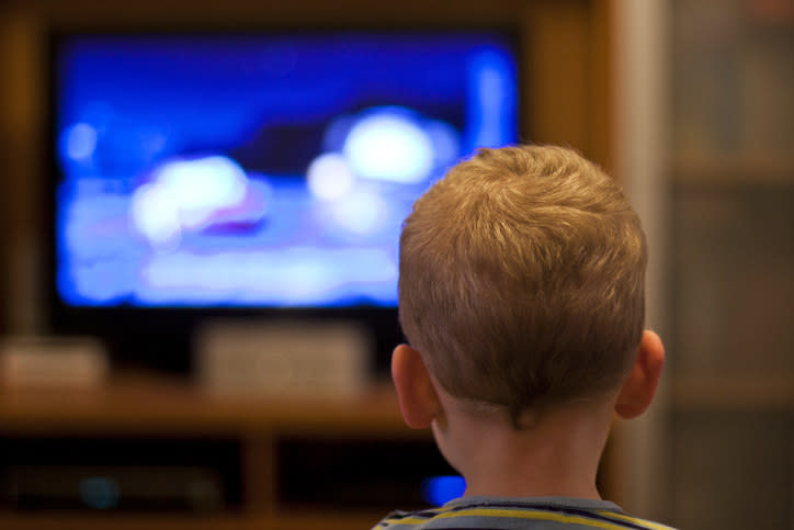 A child watching TV at night