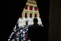 A security guard watches lawmakers debate bill promoted by Argentine President Javier Milei in Buenos Aires, Argentina, Tuesday, April 30, 2024. Congress' lower house is debating a bill promoted by Argentine President Javier Milei that includes a broad range of economic, administrative, criminal, and environmental reforms. (AP Photo/Natacha Pisarenko)