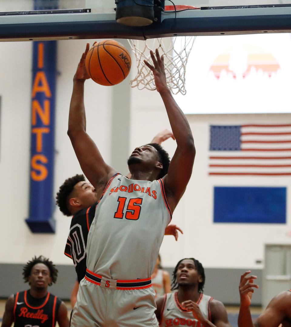 College of Sequoia's Samuel Bazunga goes up strong against Reedley College during their Central Valley Conference junior college menÕs basketball game on Wednesday, Jan. 31, 2024.