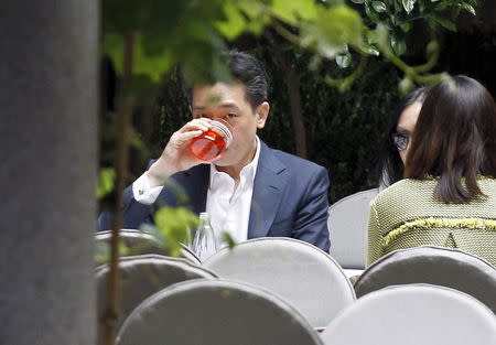 Thai businessman Bee Taechaubol drinks at a restaurant downtown in Milan, April 29, 2015. REUTERS/Alessandro Garofalo